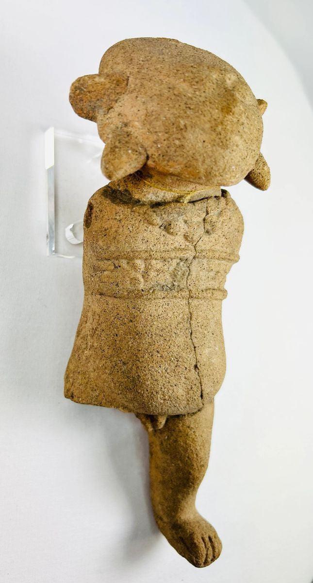 Museum-style photograph of a Pre-Columbian terracotta figurine from ancient Mesoamerica