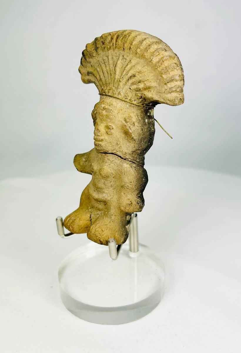 Side profile showing the fan-shaped headdress of a Pre-Columbian terracotta figurine