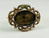 Museum-style photograph of a mid-19th-century Victorian mourning hairwork brooch.