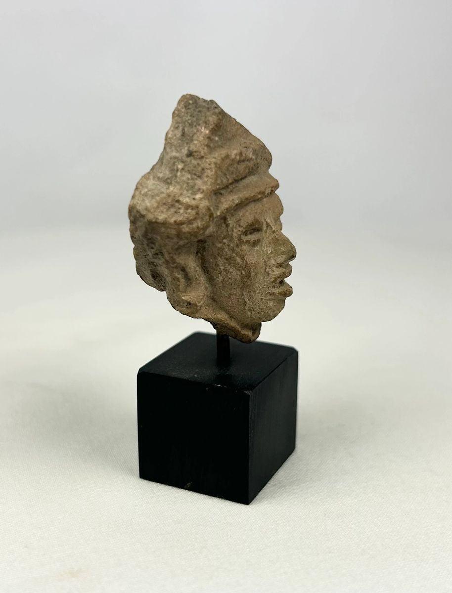 Detail view showing age-related wear on a terracotta effigy fragment