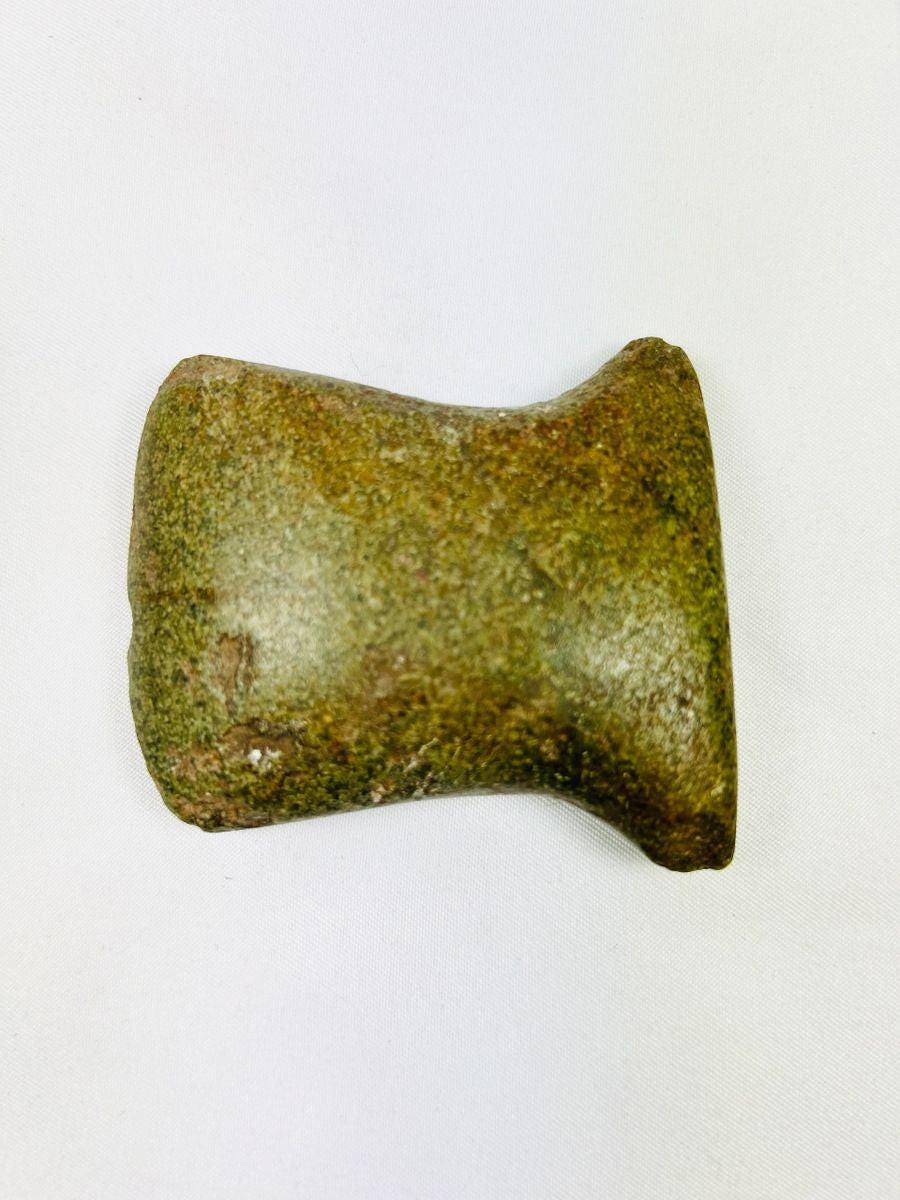 Pre-Columbian Andean tool with beveled edge and wear marks, original archaeological tag included.