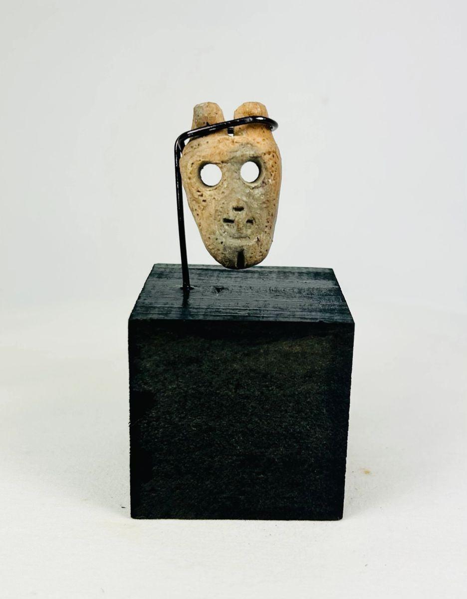 Pre-Columbian bone mask pendant with hollowed eyes and open mouth, ritual funerary object