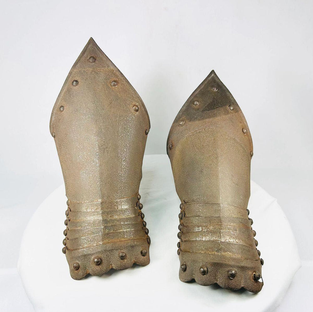 Close-up of etched decoration on Gothic-style armor gauntlets with oxidation.