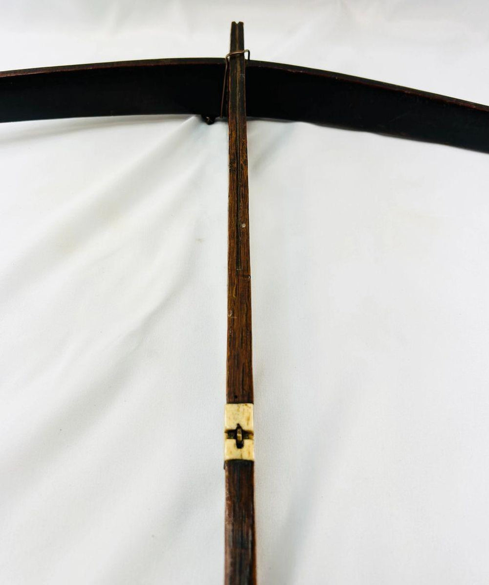 Historic Nu ethnic minority crossbow frame with aged wood texture and bone release piece.
