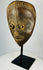 Antique Baule mask from Ivory Coast featuring almond-shaped eyes and carved coiffure