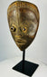 Antique Baule mask from Ivory Coast featuring almond-shaped eyes and carved coiffure