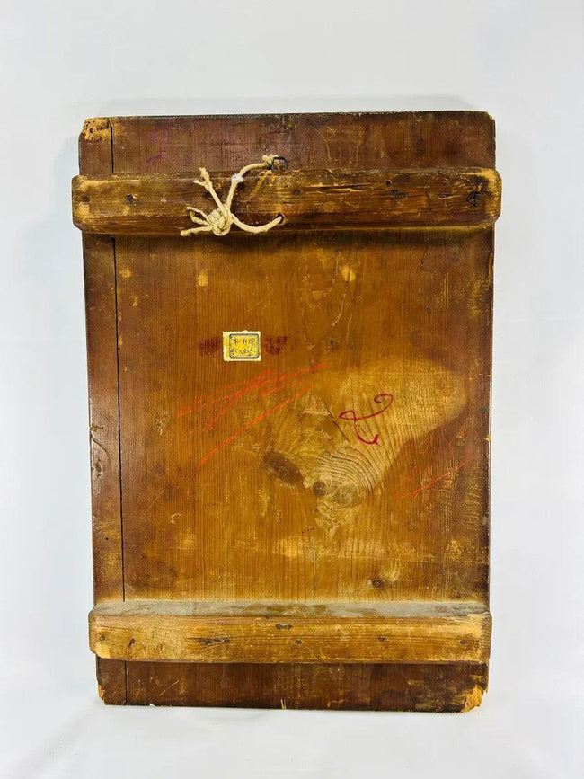 Back of antique Orthodox icon panel with wooden cross-bracing, aged patina, rope hanger and remnants of old label