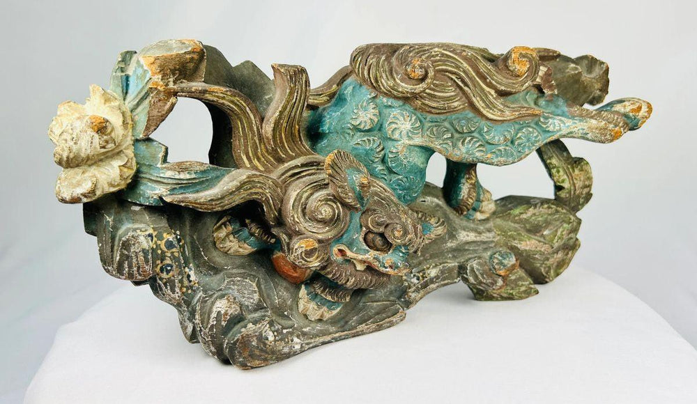 Close-up of a Qing Dynasty Qilin carving showing aged wood grain and polychrome remnants