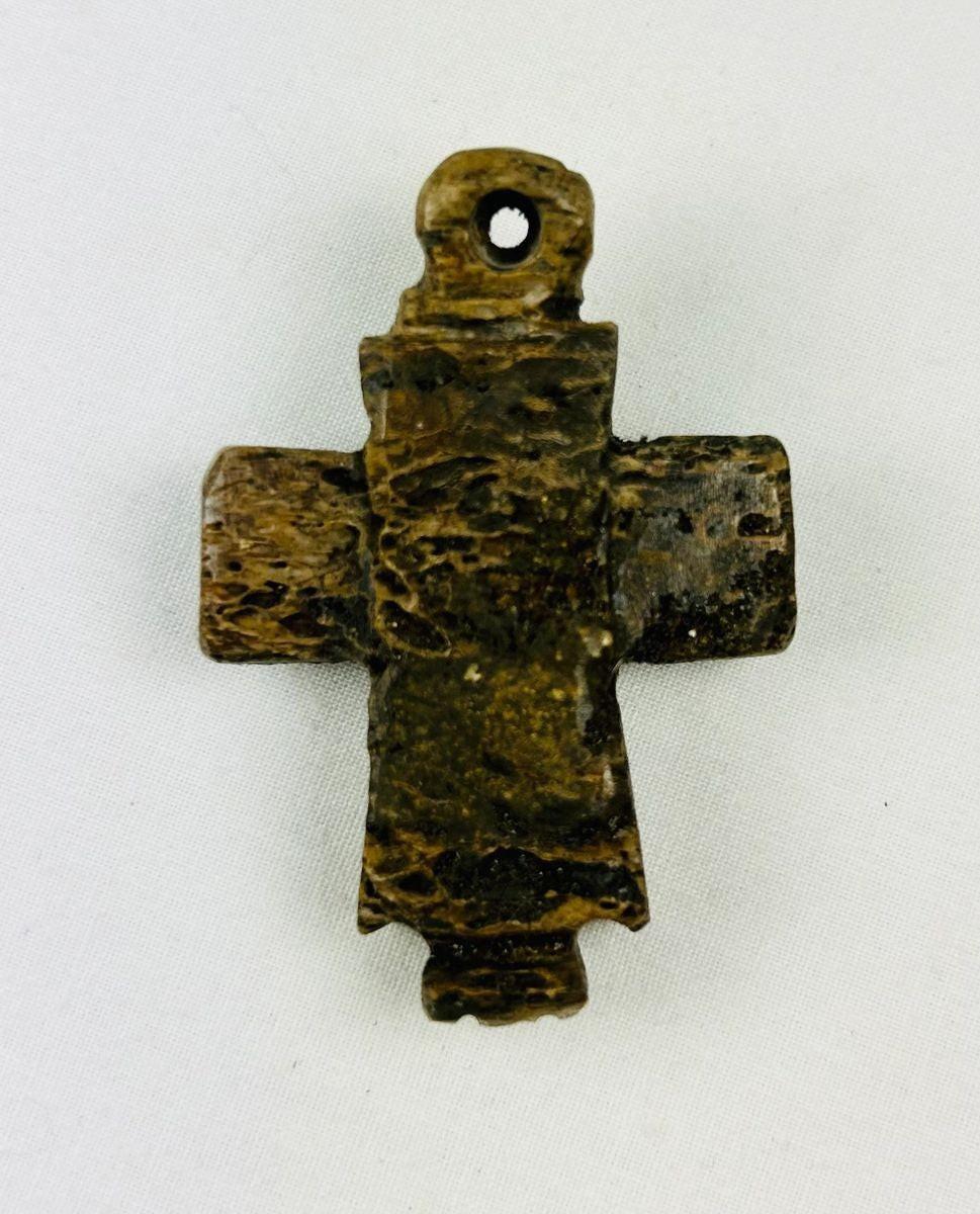 Byzantine era carved bone cross amulet with smooth aged surface and simple iconography