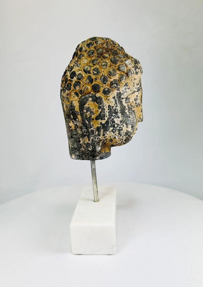 Southeast Asian Buddha head serene expression curled hair marble base