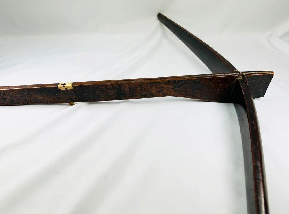 Authentic Yunnan tribal crossbow stock displaying bone toggle attachment and patina.