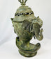 Side view of an 18th-century Qing bronze incense burner showing detailed elephant-head handle and phoenix relief.