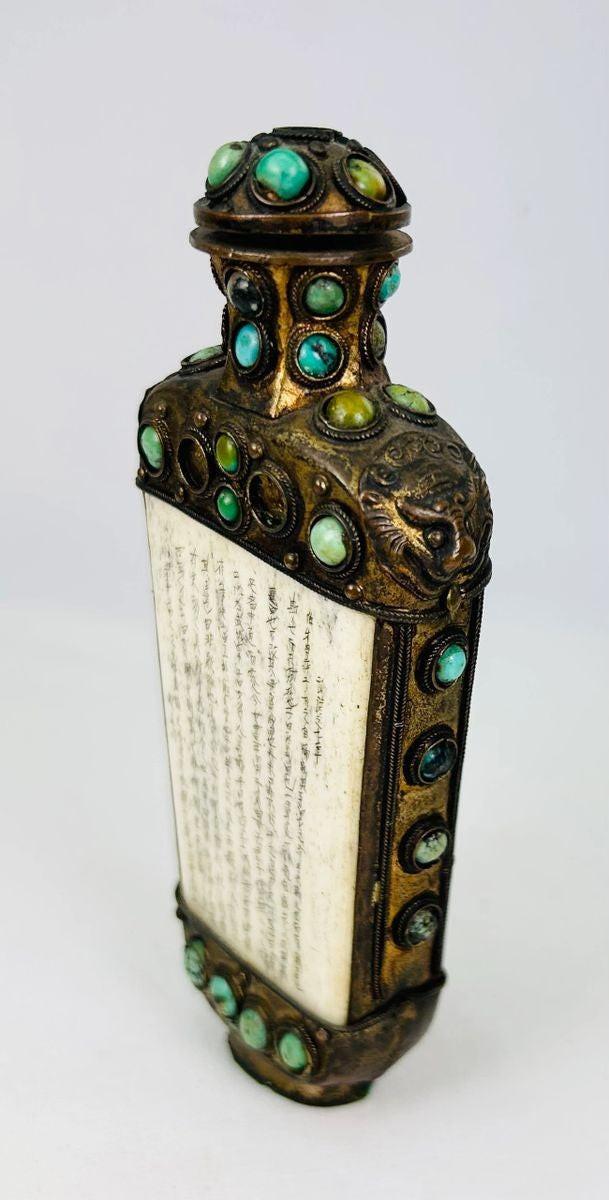 Qing Dynasty ritual flask used for Buddhist ceremonial purposes, featuring lion mask symbolism and stone-set bronze body