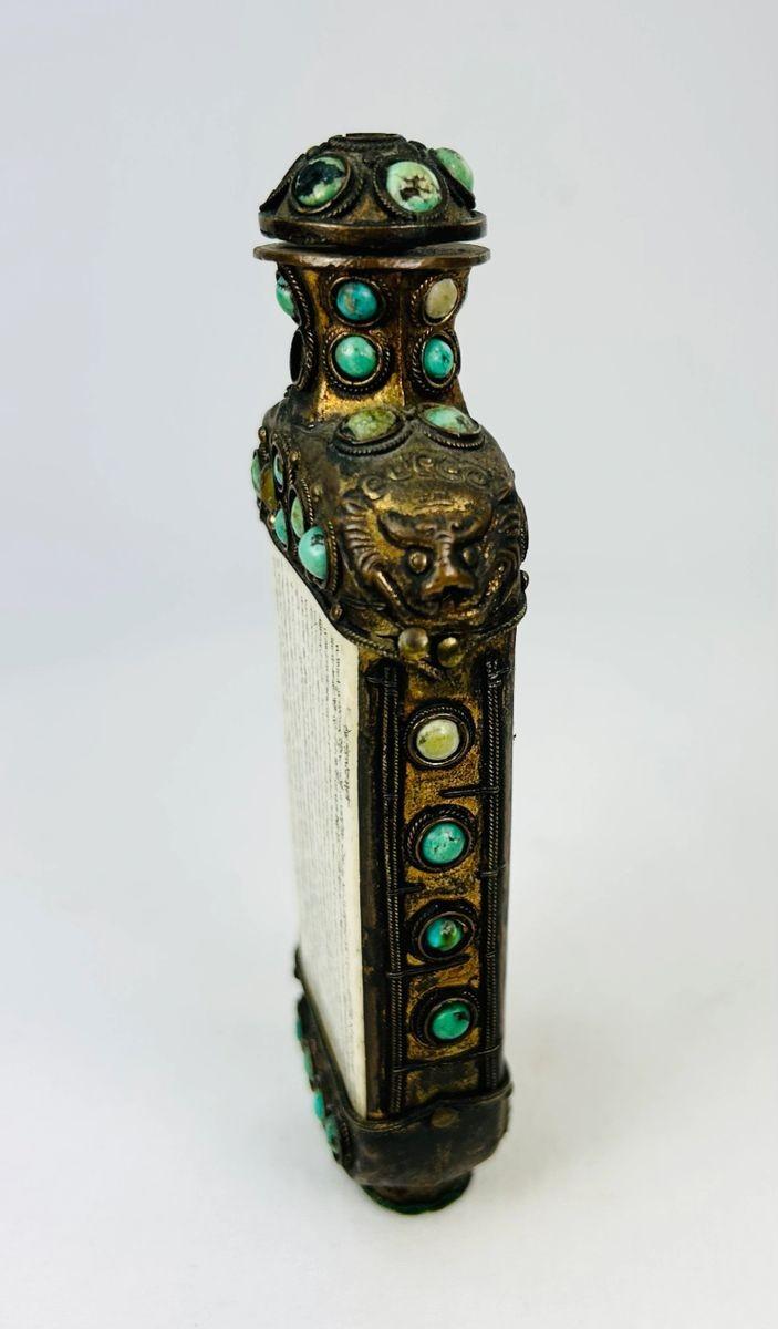 Decorative Qing Dynasty bronze ritual flask adorned with turquoise cabochons and vertical Buddhist text panels