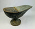 Han Dynasty bronze lamp with lid closed, highlighting engraved designs, curved body, and textured archaeological patina.
