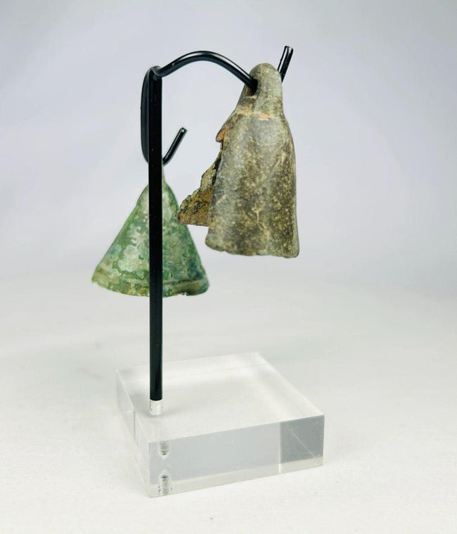 Archaeological Roman bronze bell artifact with green and brown patina from long burial