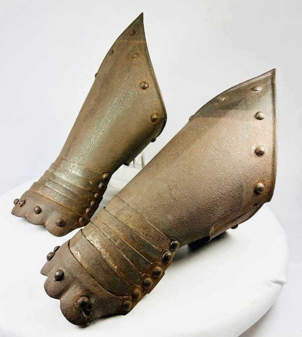 Photo showing the craftsmanship and decorative etching on Gothic-style metal gauntlets.