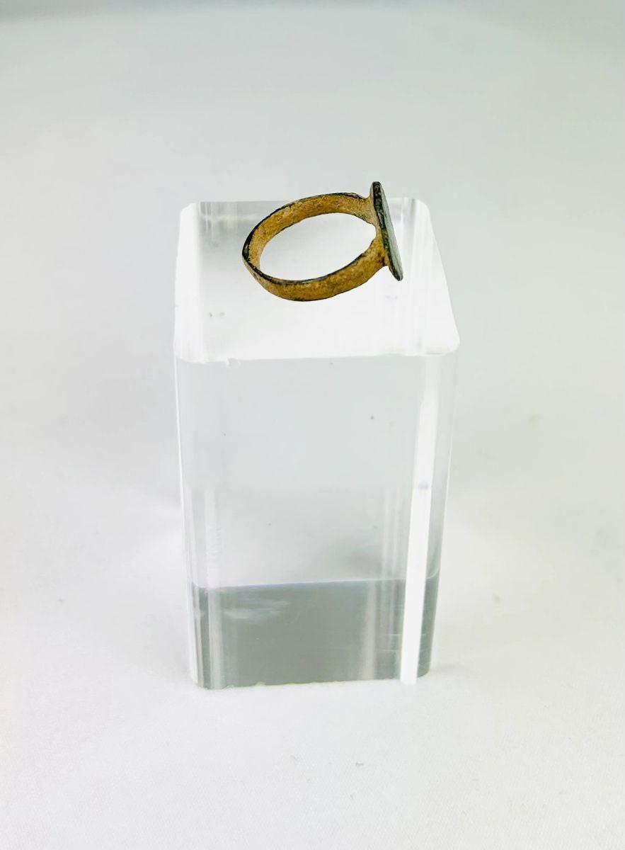 Roman bronze ring artifact photographed to show texture and incised decoration