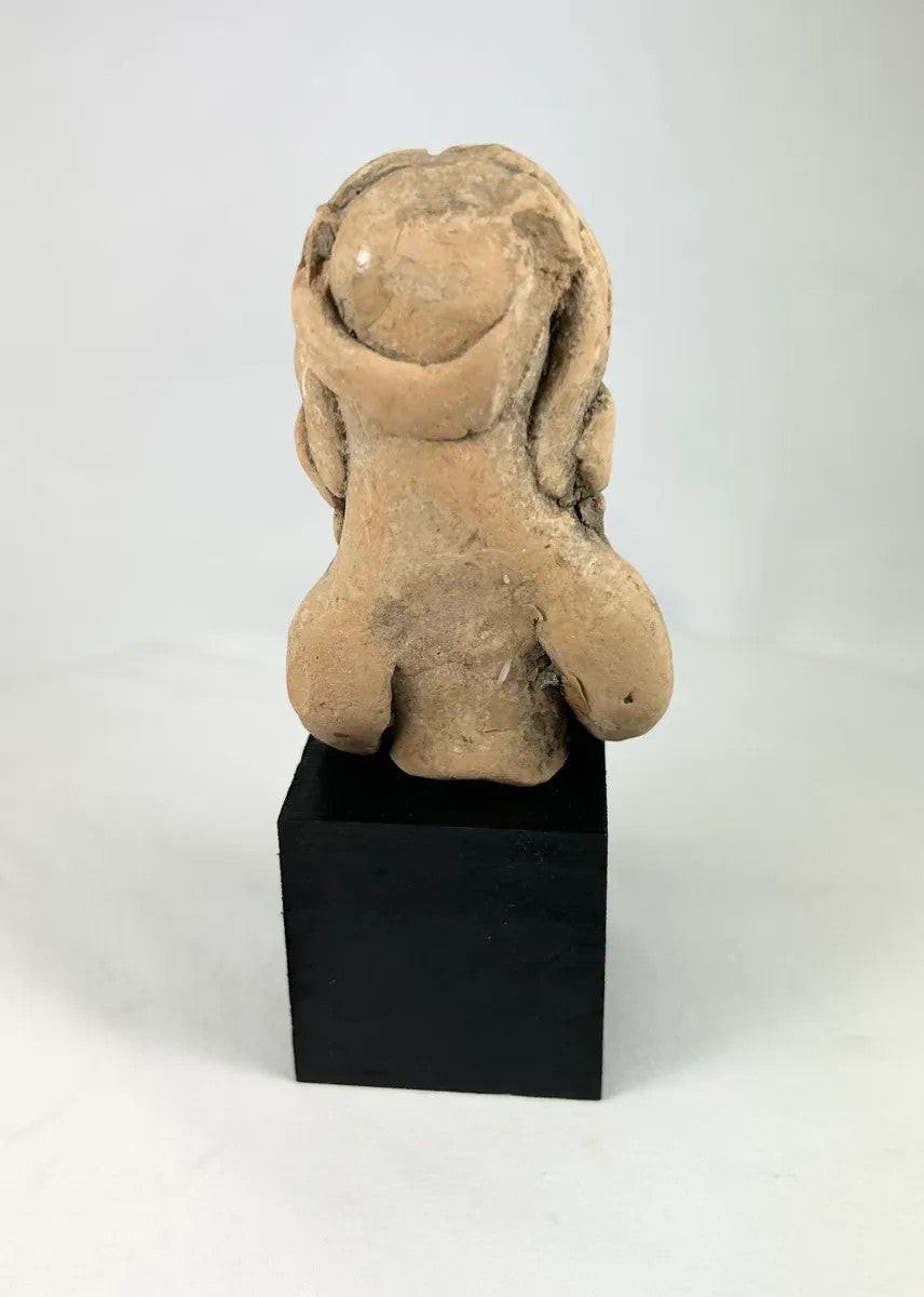 Hand-modeled West Mexico terracotta figurine depicting a seated female figure with incised headdress