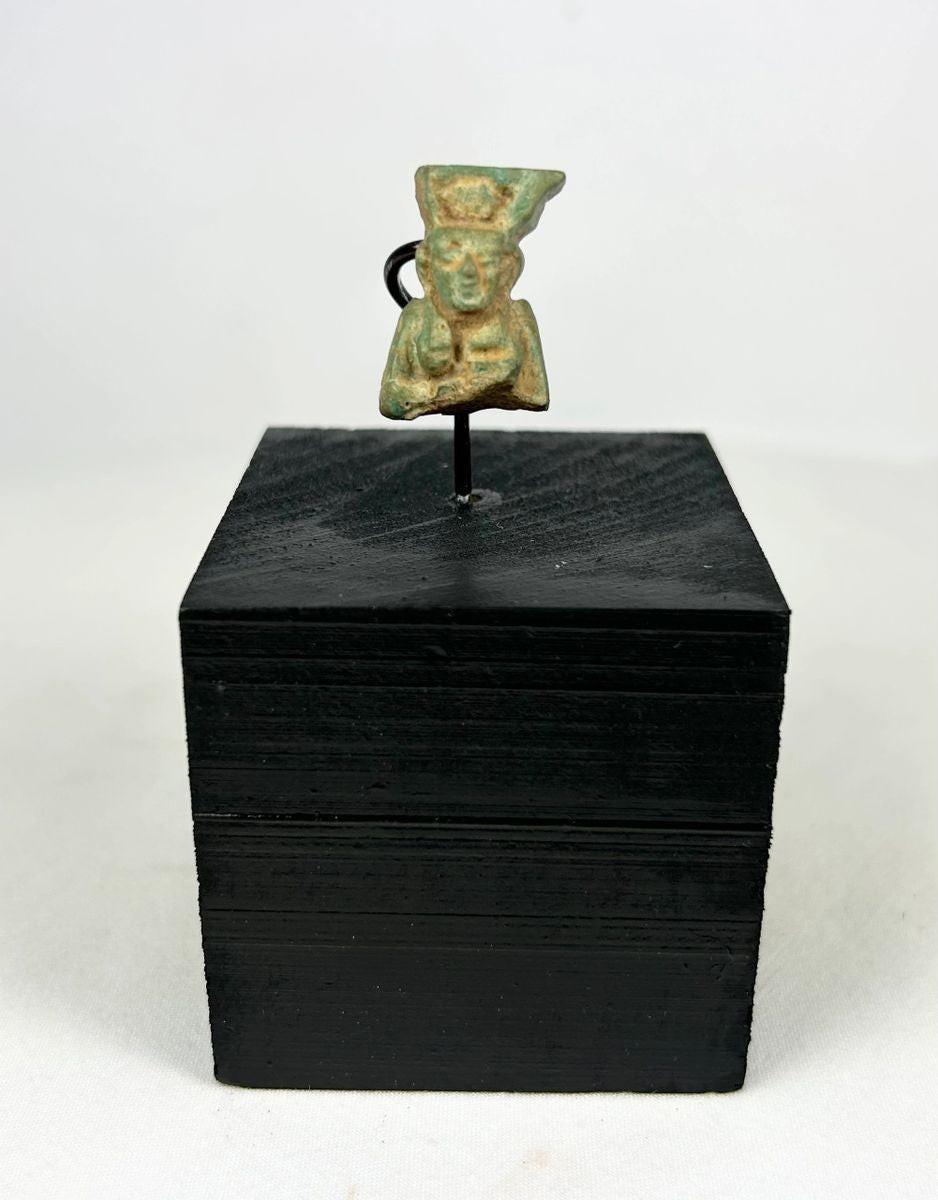 lion headed goddess sekhmet amulet on black wooden stand