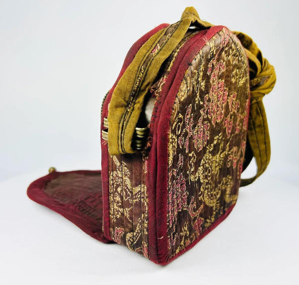 Tibetan Buddhist gau shrine featuring seated Buddha and auspicious symbols