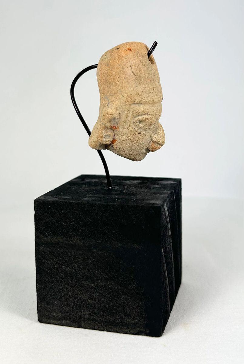 Pre-Columbian Mesoamerican terracotta head with suspension hole