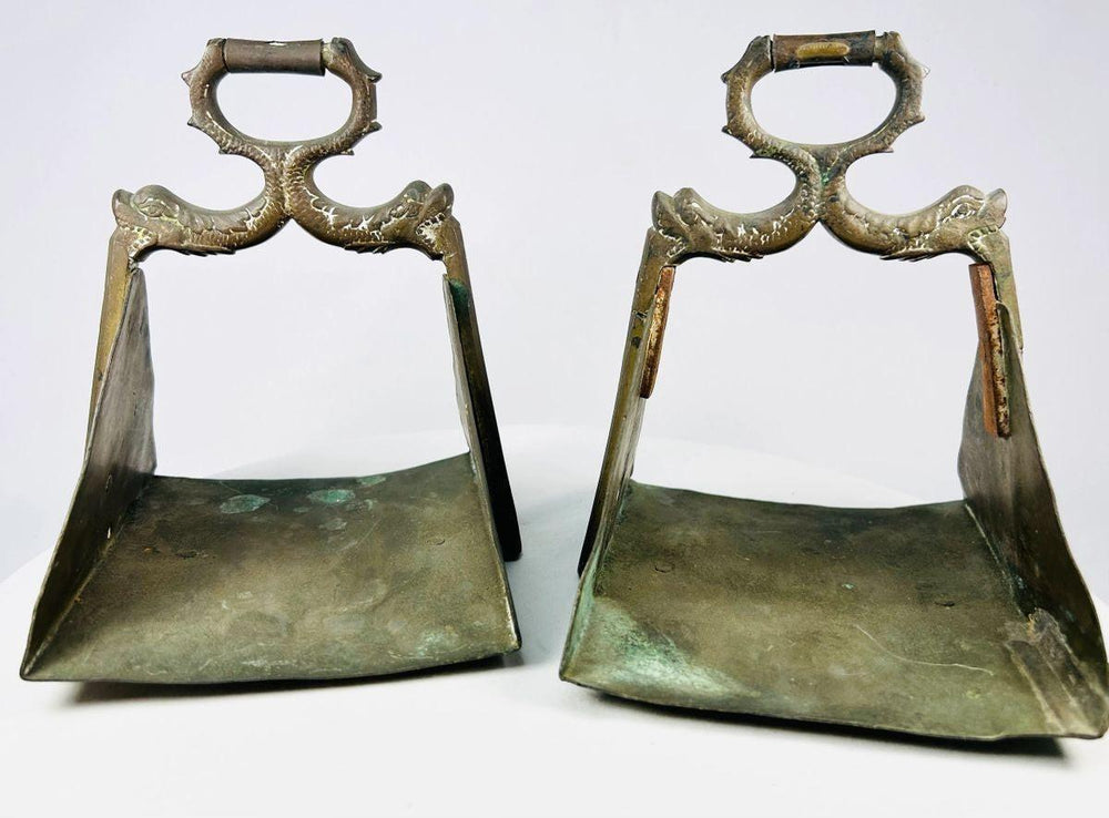 Equestrian stirrups with symbolic serpent motifs representing protection