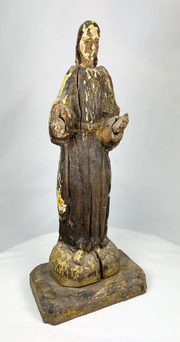 Detailed view of the hands and gesture of a Spanish Colonial santo religious sculpture