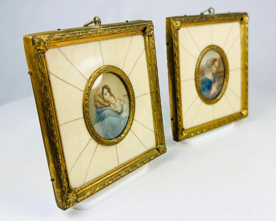 Pair of 19th century hand-painted miniature portraits in gilt frames with ivory-style panel insets. Depicting devotional female figures, one in prayer and one cradling a child. Original rectangular frames with oval portrait centers, fine detail and patina.