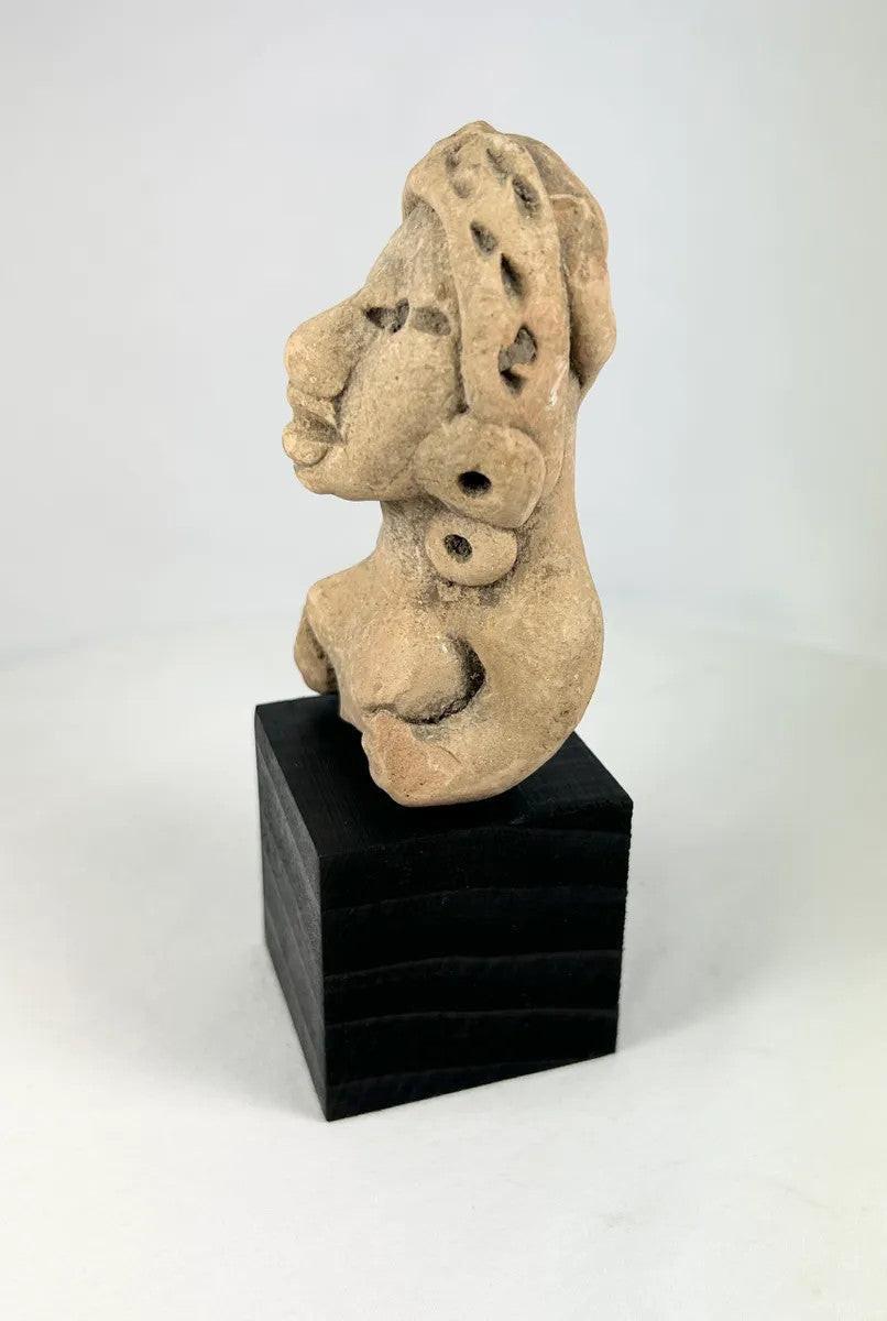 Pre-Columbian terracotta female figure from Nayarit or Jalisco, seated with arms resting on knees