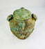 Side view of early Chinese bronze ritual vessel with lid and looped handles, Shang–Zhou Dynasty, circa 1600–256 BCE, authentic ancient artifact.