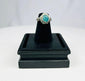 Near Eastern or Mediterranean silver ring with raised turquoise bezel and protective symbolism