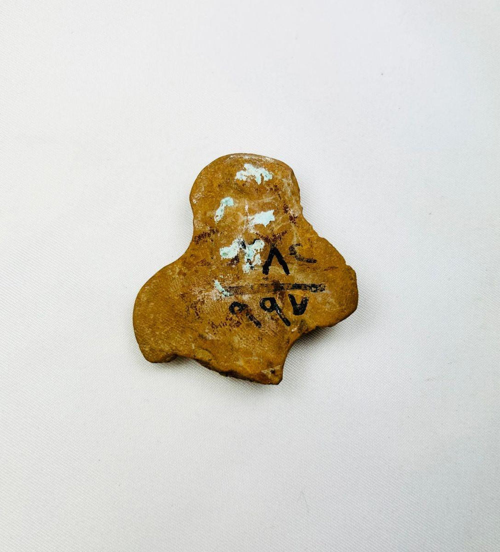 Detailed image of backside of a Ptolemaic terracotta figurine torso highlighting texture and craftsmanship.