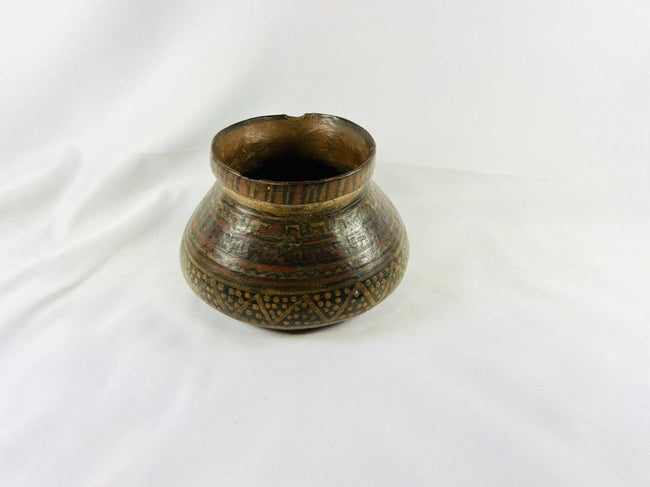 Ancient Mesoamerican ceramic vessel with flared neck and geometric painted motifs, Pre-Columbian period.