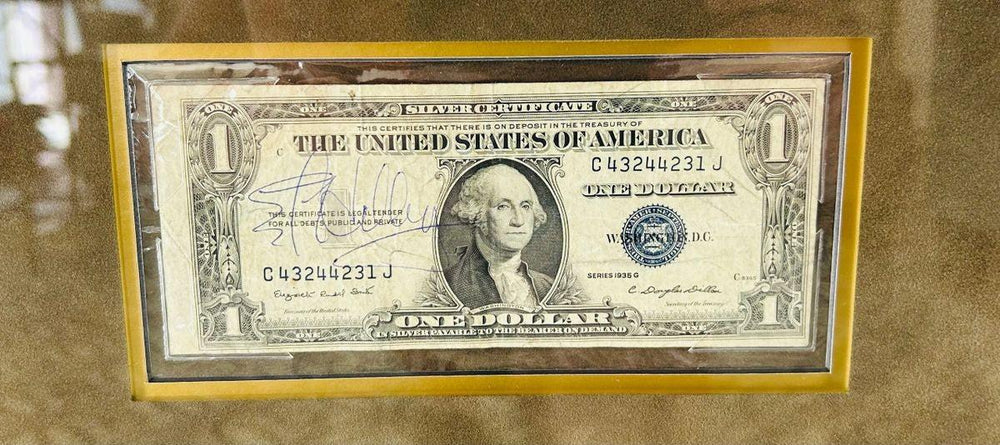 Authentic Sir Edmund Hillary hand-signed U.S. $1 silver certificate, mid-20th century. Signature clearly visible in blue ink, professionally mounted and preserved within the framed Everest tribute display honoring the legendary mountaineer and explorer.