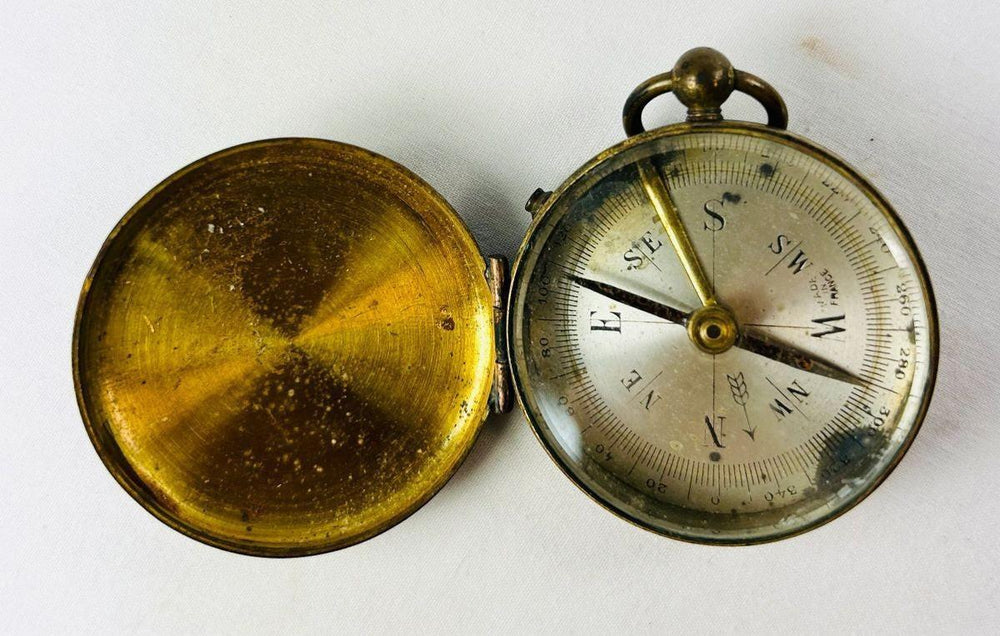 Antique French brass pocket compass with hinged lid and engraved azimuth scale, circa 1880–1920.