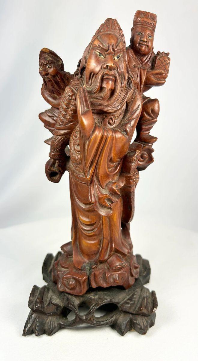 Qing Dynasty wood sculpture with flowing robes and fierce expression