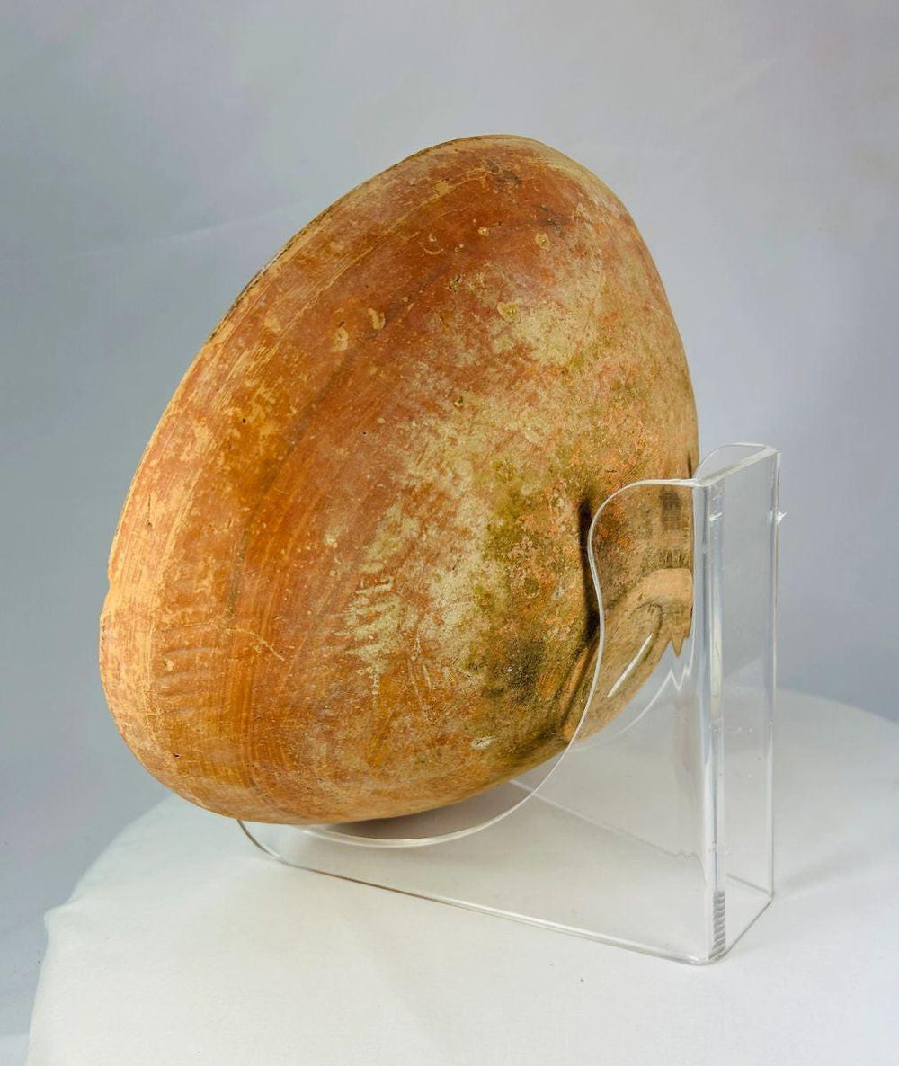 Ancient Indus Valley ceramic bowl with hand-painted geometric decoration on terracotta surface.