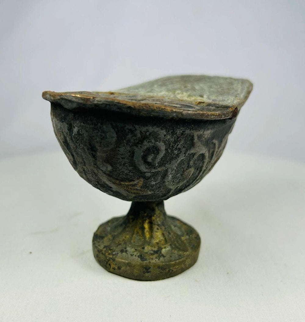 Full frontal view of Han Dynasty bronze lamp, emphasizing pedestal foot, rounded bowl, and swirling decorative motifs.