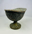 Full frontal view of Han Dynasty bronze lamp, emphasizing pedestal foot, rounded bowl, and swirling decorative motifs.
