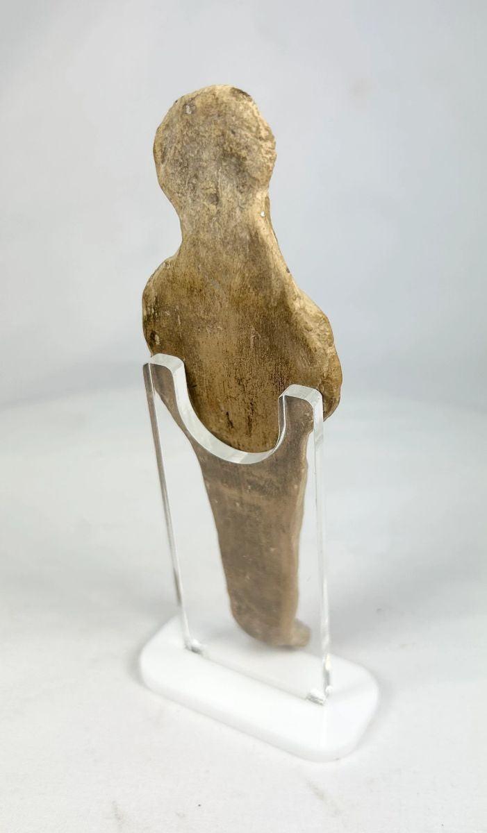 Side view of Roman fertility statuette highlighting form, texture, and ritual posture.