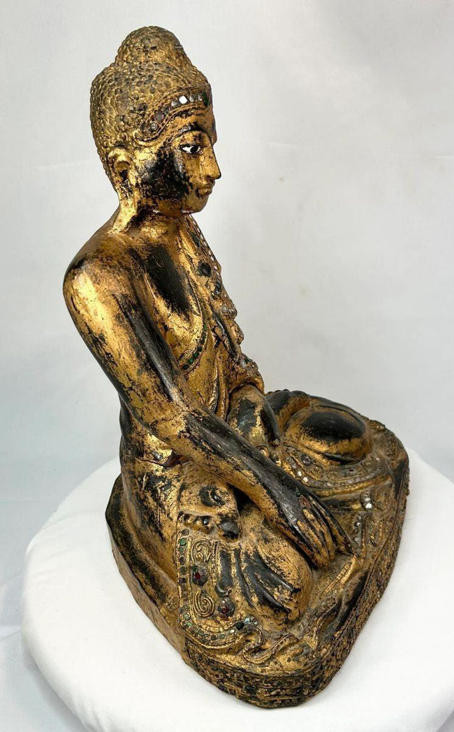 Thai Buddha in Bhumisparsha Mudra – hand-carved gilt wooden figure with glass inlays, 19th–early 20th century temple art from Thailand, symbolizing enlightenment and spiritual awakening.