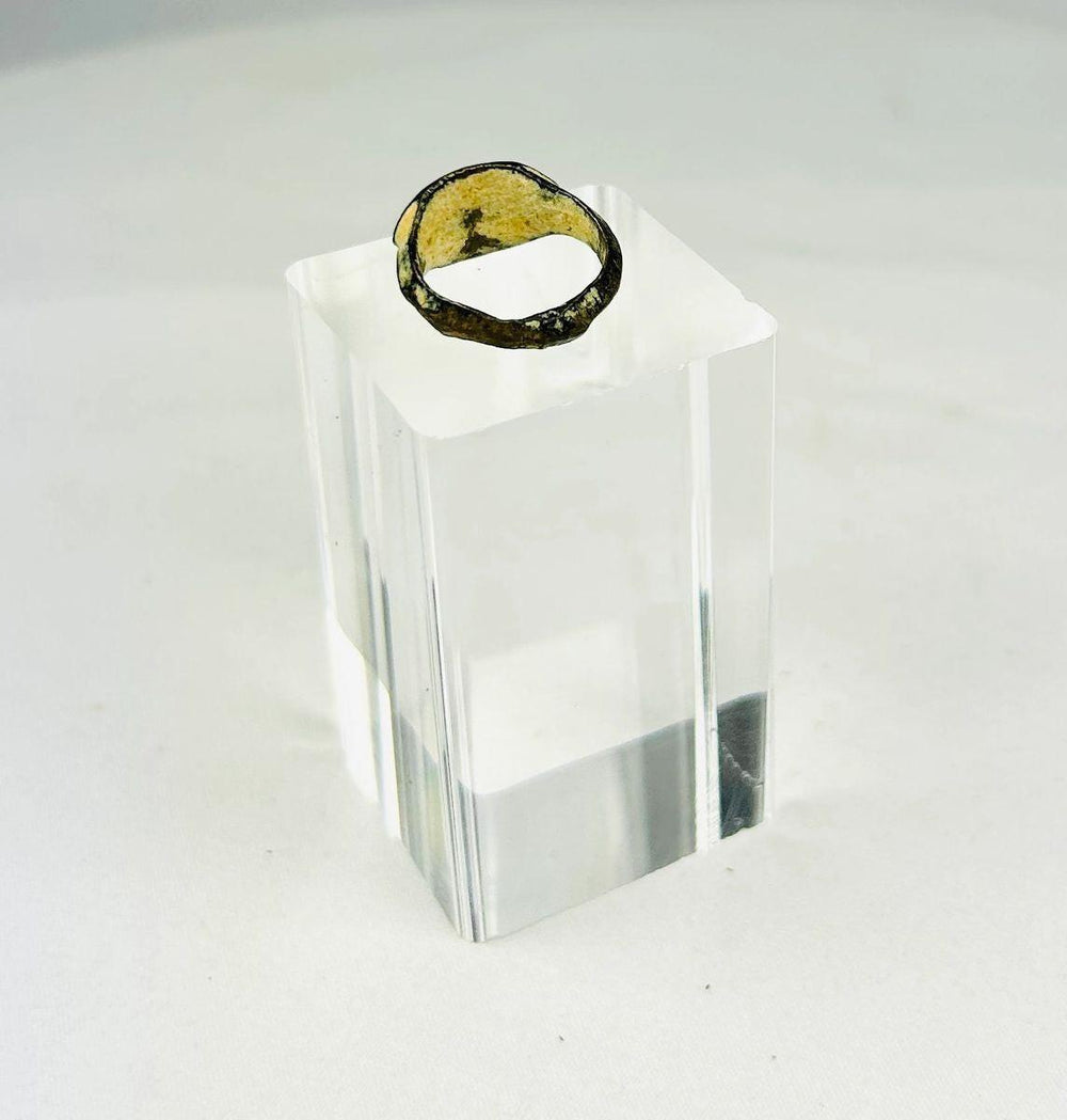 Angled view of ancient Roman ring showing engraved bezel and band profile.