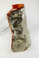 Authentic flown NASA Space Shuttle insulation blanket made of fibrous silica batting with reflective silver thermal surface and orange edge seal, used in the Orbiter Thermal Protection System (TPS), stamped April 1983 with serial number and manufacturer code visible on the metal tag, approximately 11 by 10 inches, aerospace artifact from the Space Shuttle Program.