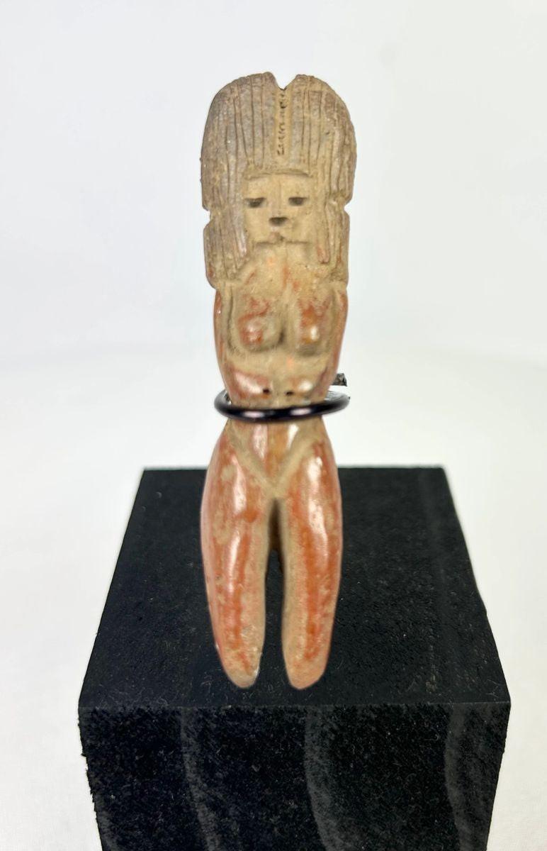 Classic Veracruz seated female terracotta figurine with vertical headdress, circa 600–900 CE