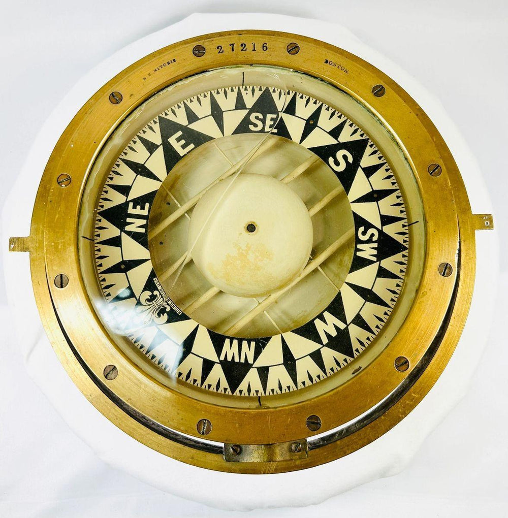 Historical brass ship compass by E.S. Ritchie, representing early 1900s marine craftsmanship.