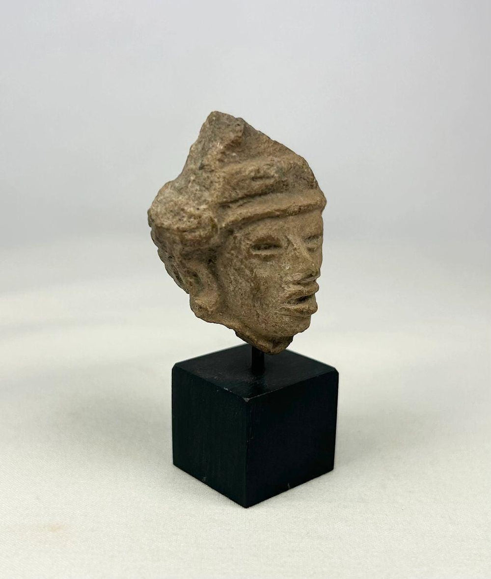 Side profile view showing hand-modeled features of a terracotta effigy fragment