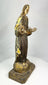 Side profile of a Spanish Colonial santo religious statue carved in wood with visible patina