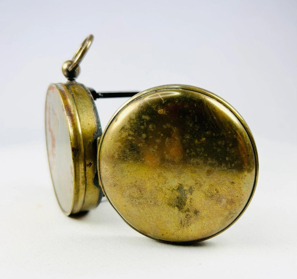 Side view of a French brass pocket compass highlighting the working sighting lens.