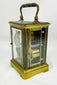 Elegant antique carriage clock by Jules Bunelot with polished brass and enamel detailing.